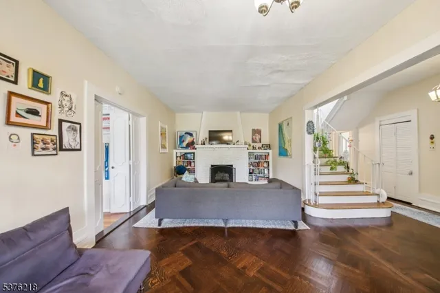 a view of a livingroom with wooden floor and white walls