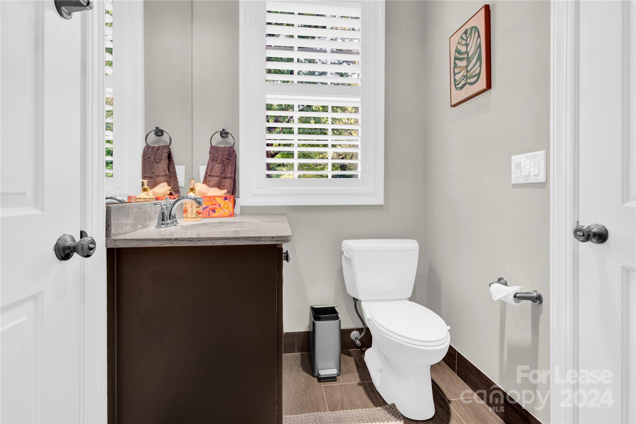 3012 Sharon View Road Charlotte, NC 28210 - Photo 11 of 48 a bathroom with a toilet sink and mirror