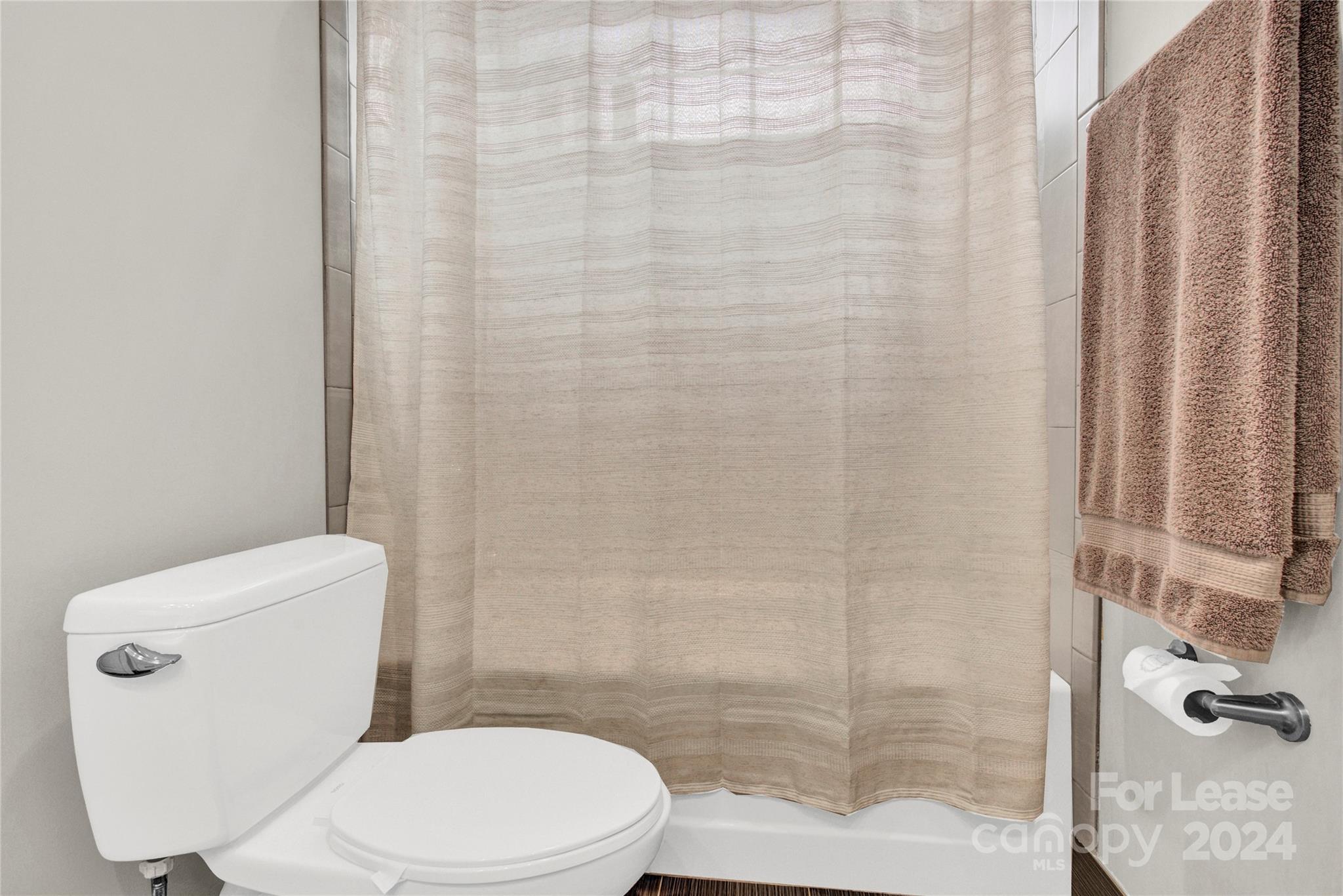 3012 Sharon View Road Charlotte, NC 28210 - Photo 14 of 48 a white toilet sitting next to a shower