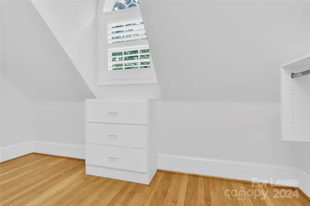 a view of an empty room and wooden floor