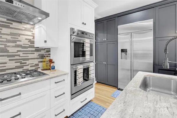 a kitchen with stainless steel appliances kitchen island granite countertop a refrigerator and a stove