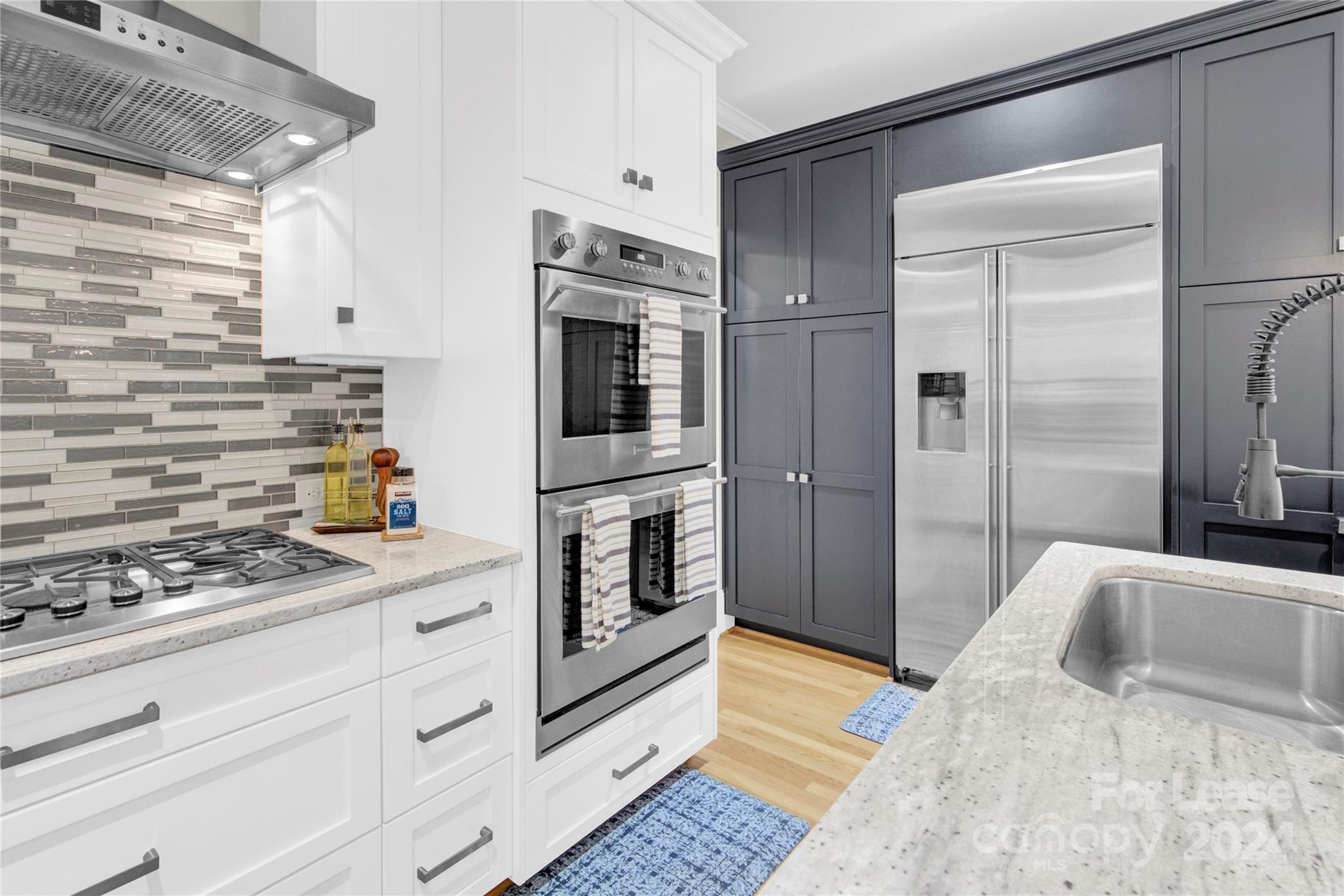 3012 Sharon View Road Charlotte, NC 28210 - Photo 25 of 48 a kitchen with stainless steel appliances kitchen island granite countertop a refrigerator and a stove