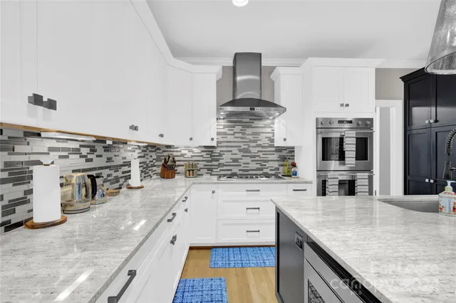 a kitchen with stainless steel appliances granite countertop a sink and cabinets
