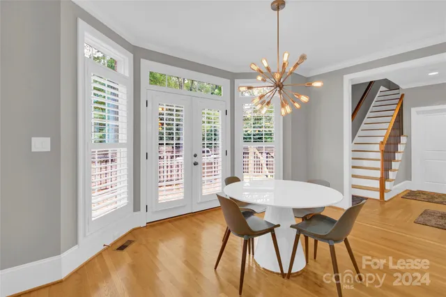 a view of a dining room with furniture and a chandelier
