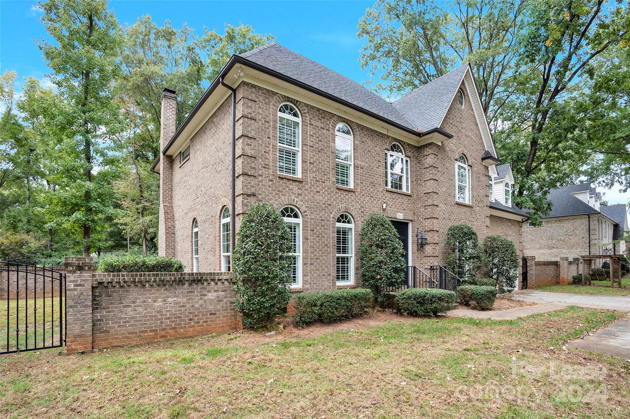 3012 Sharon View Road Charlotte, NC 28210 - Photo 3 of 48 a front view of a house with a yard and garage
