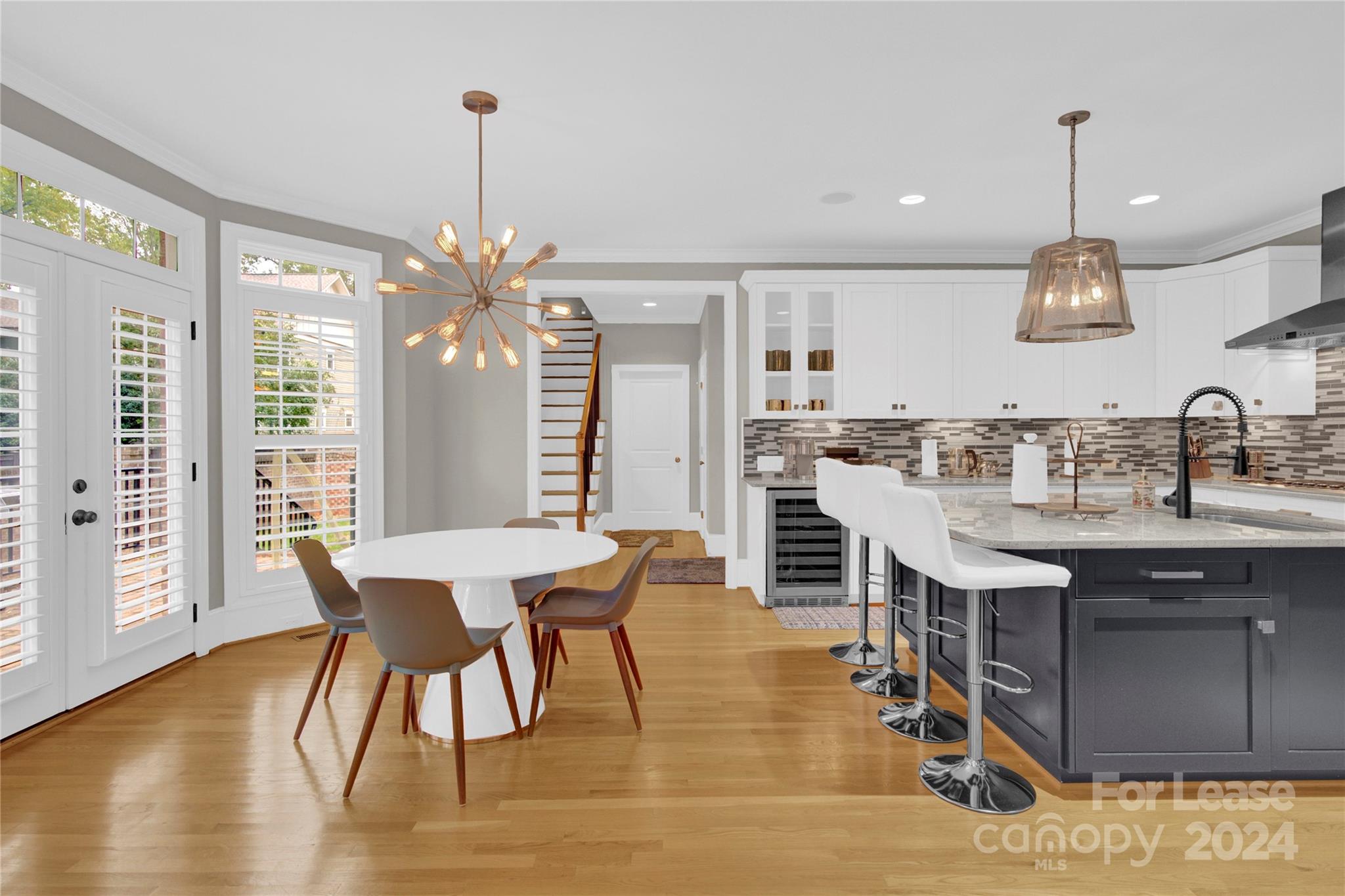 3012 Sharon View Road Charlotte, NC 28210 - Photo 31 of 48 a kitchen with stainless steel appliances kitchen island granite countertop a table chairs sink and wooden floor