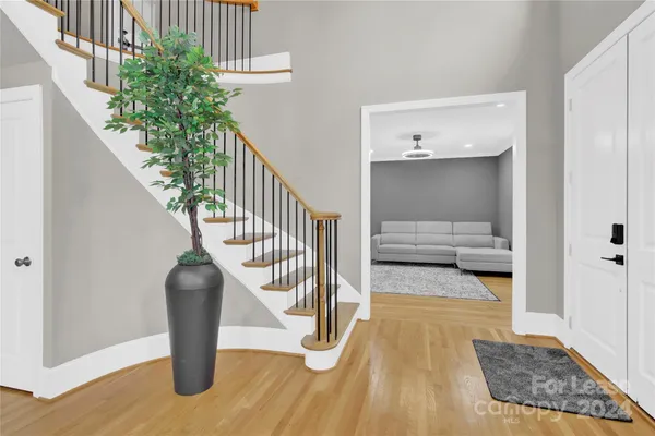 a view of entryway and hall with wooden floor