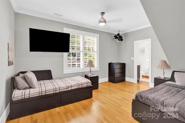 a bedroom with a bed couch and window