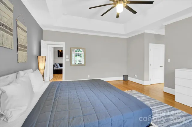 a bedroom with a bed and a chandelier