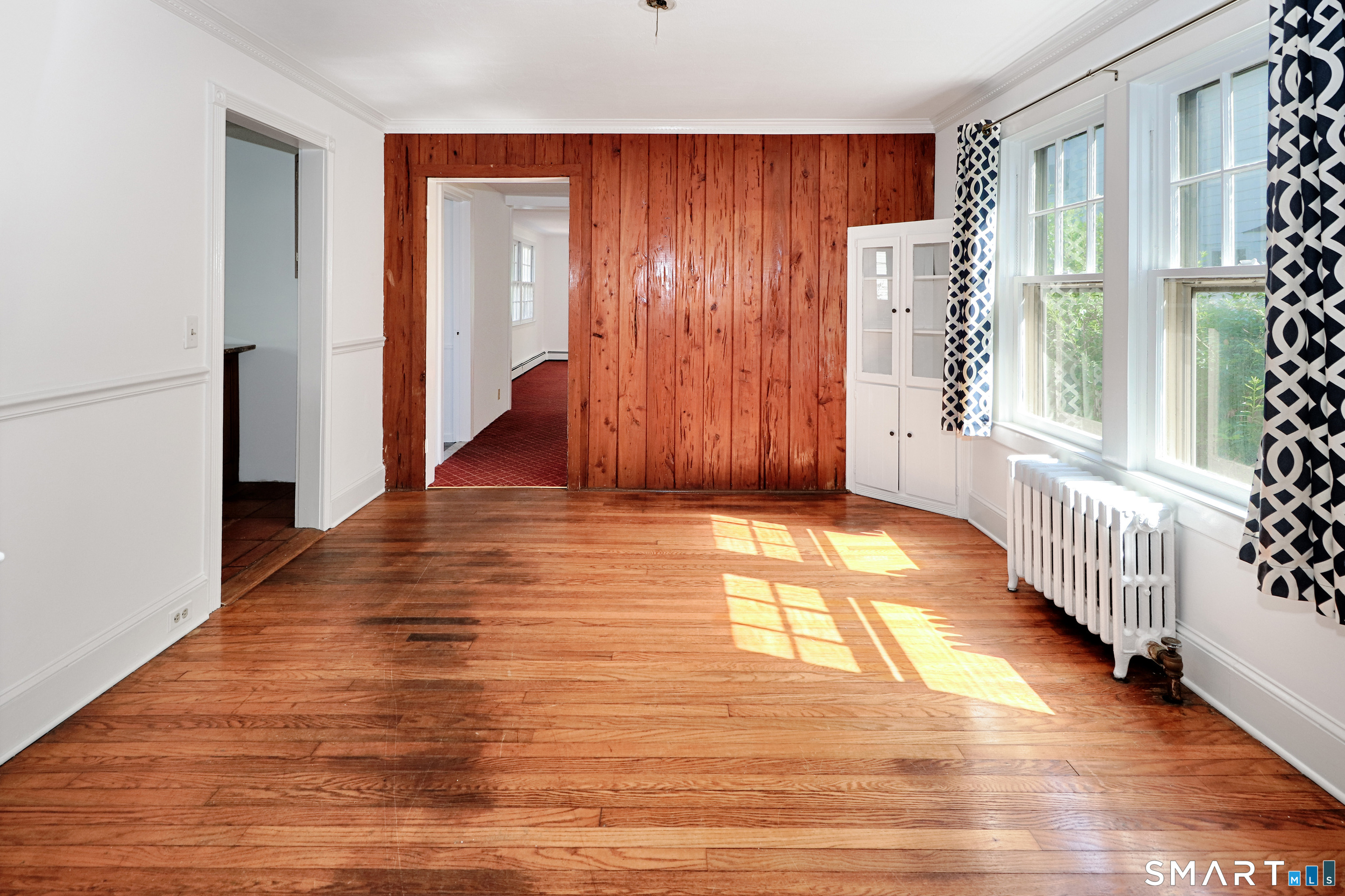 104 Henderson Road Fairfield, CT 06824 - Photo 7 of 26 Dining Room with Hardwood Floor and a Pecky Cypress accent Wall