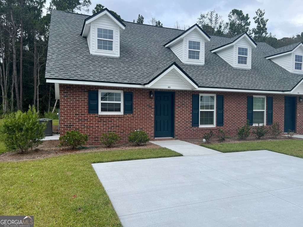 405 Madison Avenue St. Marys, GA 31558 - Photo 1 of 21 a front view of a house with a yard and garage