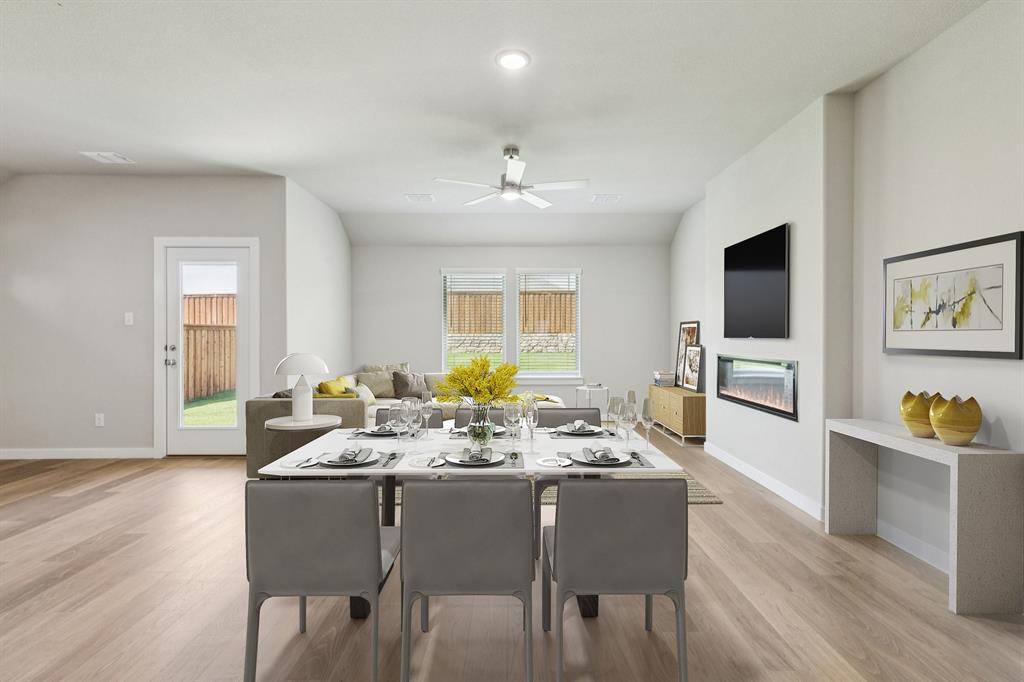 1468 Companero Street Haslet, TX 76052 - Photo 9 of 29 a view of a dining room with furniture window and wooden floor