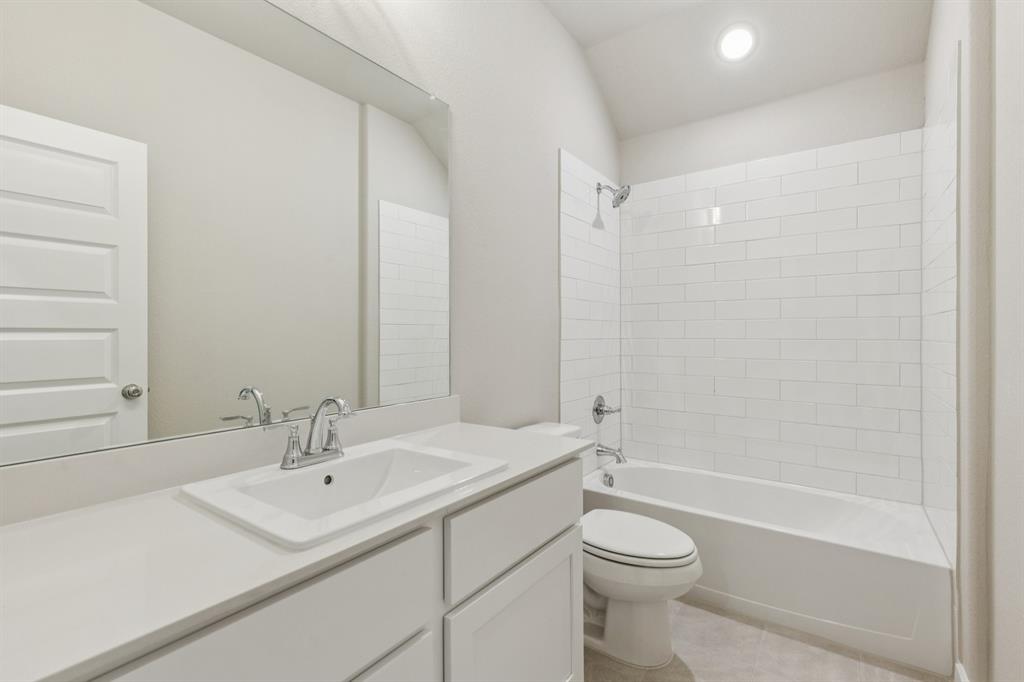 1468 Companero Street Haslet, TX 76052 - Photo 19 of 29 a bathroom with a sink a toilet and shower