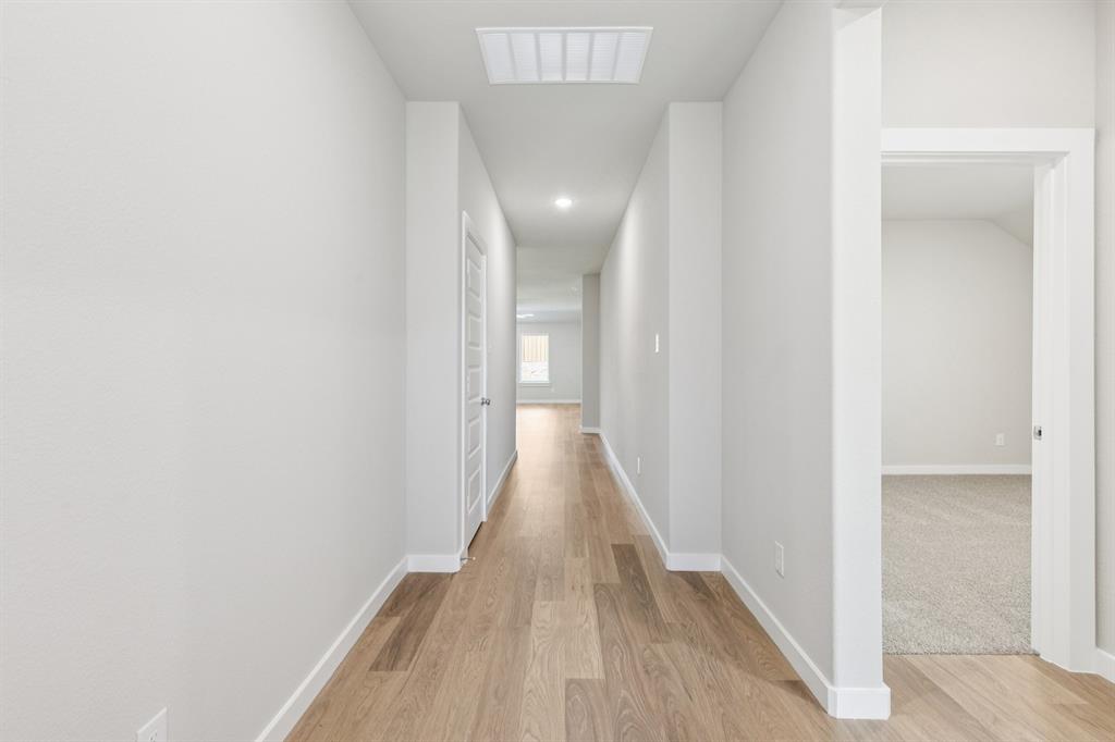 1468 Companero Street Haslet, TX 76052 - Photo 21 of 29 a view of a hallway with wooden floor