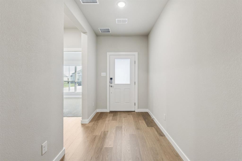 1468 Companero Street Haslet, TX 76052 - Photo 22 of 29 an empty room with wooden floor and windows
