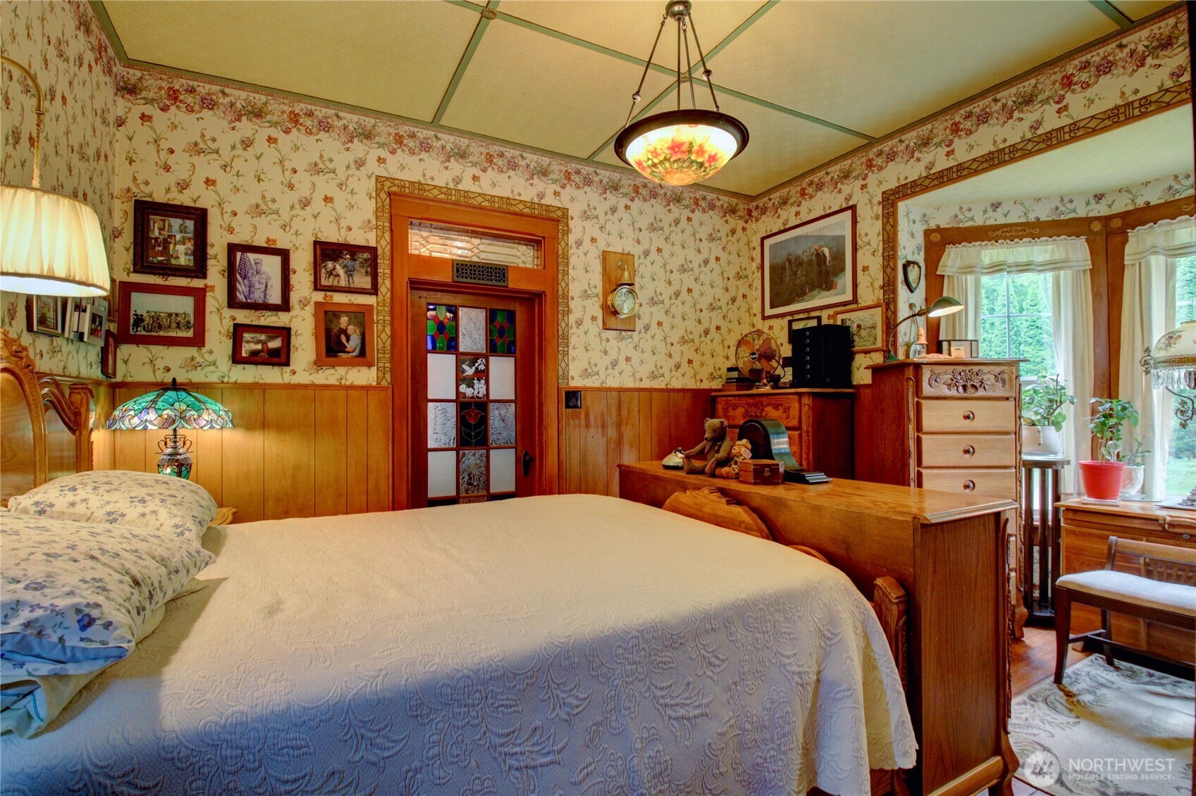 2909 Overpass Road Bow, WA 98232 - Photo 11 of 40 a bedroom with a bed and a chandelier