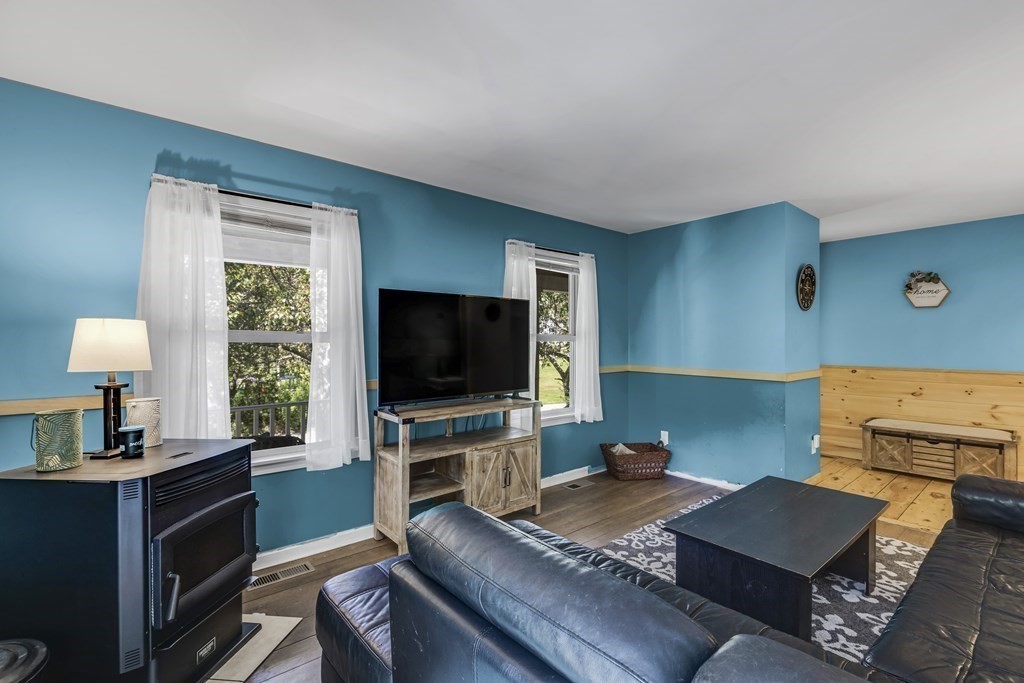 24 Sand Hill Road Salisbury, MA 01952 - Photo 12 of 28 a living room with furniture and a flat screen tv