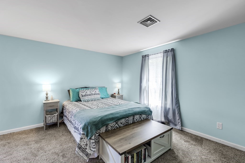 24 Sand Hill Road Salisbury, MA 01952 - Photo 17 of 28 a bedroom with a bed and a window