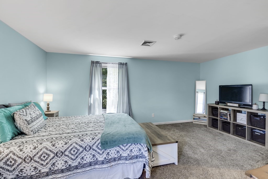 24 Sand Hill Road Salisbury, MA 01952 - Photo 19 of 28 a bedroom with a bed and a flat screen tv