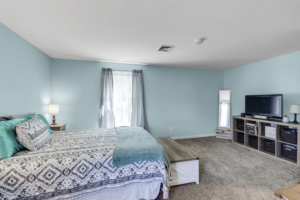 24 Sand Hill Road Salisbury, MA 01952 - Photo 20 of 28 a bedroom with a bed and a flat screen tv