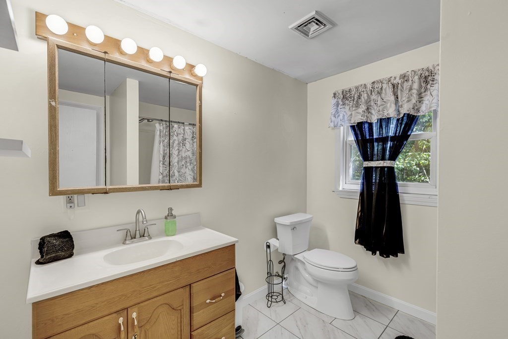 24 Sand Hill Road Salisbury, MA 01952 - Photo 21 of 28 a bathroom with a sink a toilet and a mirror