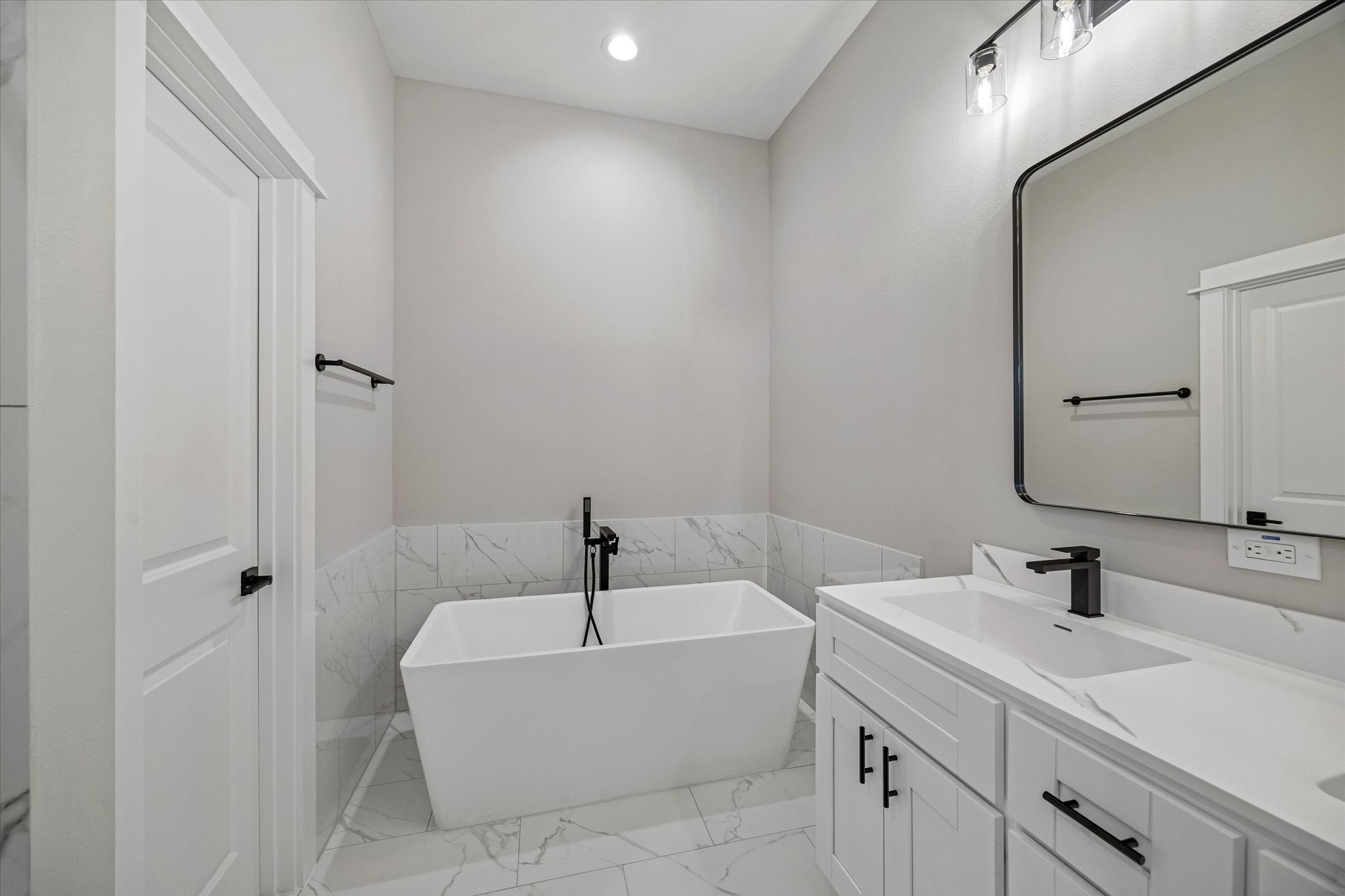 11307 Stonework Grove Lane Houston, TX 77076 - Photo 41 of 46 a bathroom with a tub sink and mirror