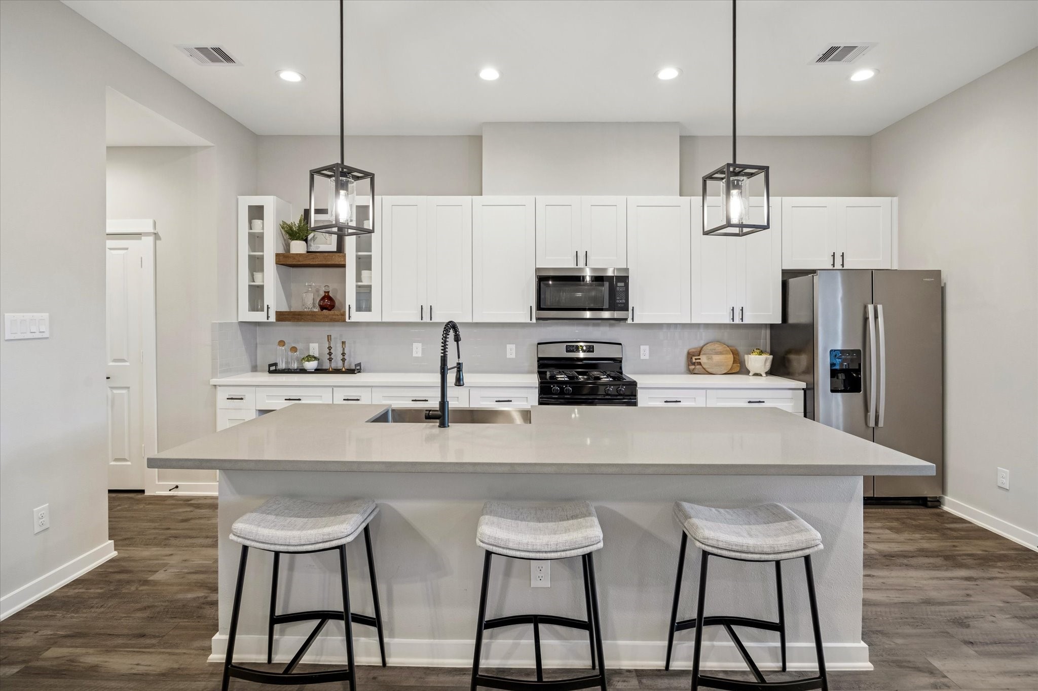 11307 Stonework Grove Lane Houston, TX 77076 - Photo 9 of 46 a kitchen with refrigerator a sink and chairs