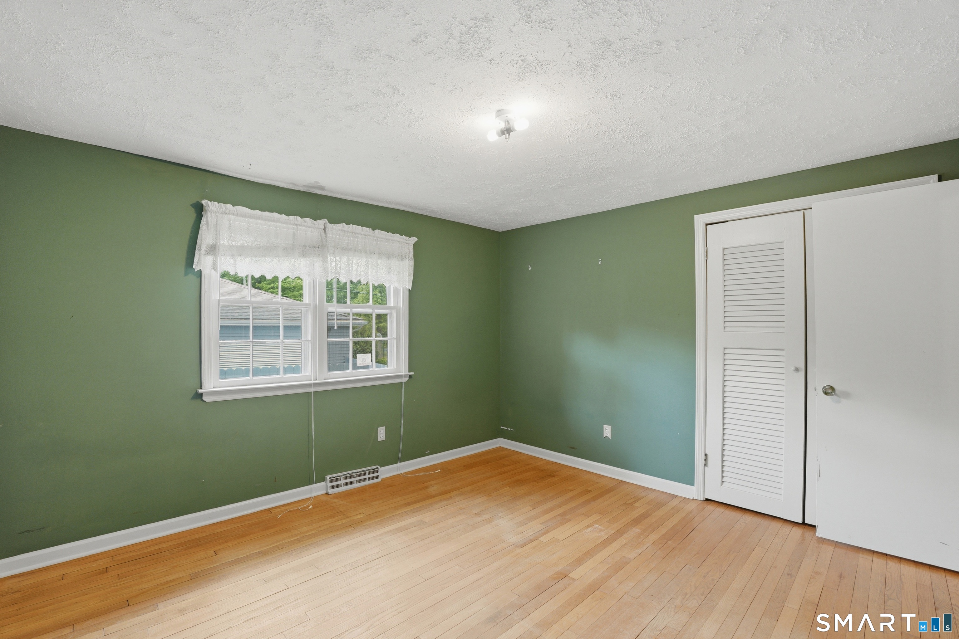 731 Still Hill Road Hamden, CT 06518 - Photo 22 of 40 an empty room with wooden floor and windows