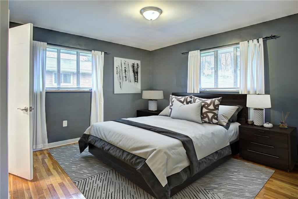 118 Siebert Road Pittsburgh, PA 15237 - Photo 16 of 25 a bedroom with a bed and wooden floor