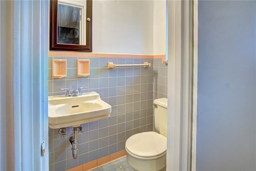 118 Siebert Road Pittsburgh, PA 15237 - Photo 17 of 25 a bathroom with a toilet a sink and mirror