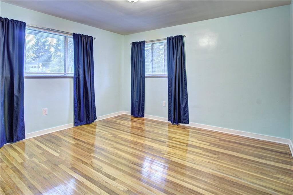 118 Siebert Road Pittsburgh, PA 15237 - Photo 18 of 25 a view of a bedroom with wooden floor and windows