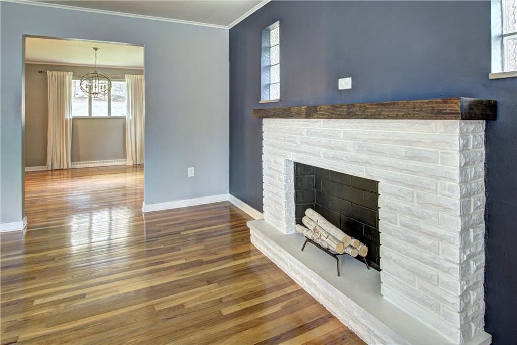 118 Siebert Road Pittsburgh, PA 15237 - Photo 6 of 25 a view of an empty room with wooden floor and a fireplace