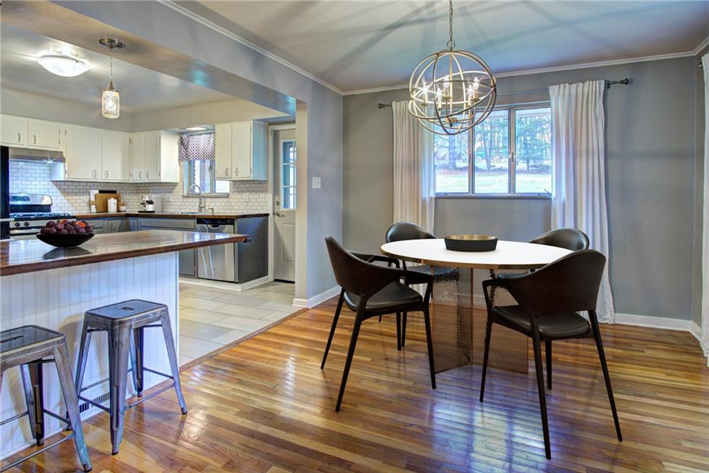 118 Siebert Road Pittsburgh, PA 15237 - Photo 7 of 25 a view of a dining room with furniture a chandelier and wooden floor