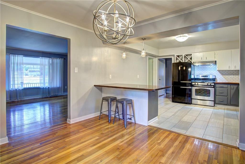 118 Siebert Road Pittsburgh, PA 15237 - Photo 8 of 25 a open kitchen with stainless steel appliances granite countertop a dishwasher kitchen island a cabinets and wooden floor