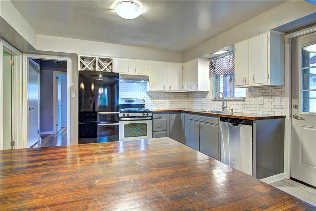 118 Siebert Road Pittsburgh, PA 15237 - Photo 9 of 25 a kitchen with granite countertop a stove top oven and cabinets