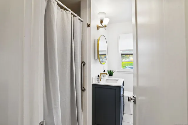 a bed sitting in a bedroom next to a window