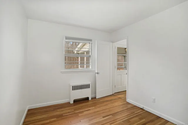 a view of room with wooden floor