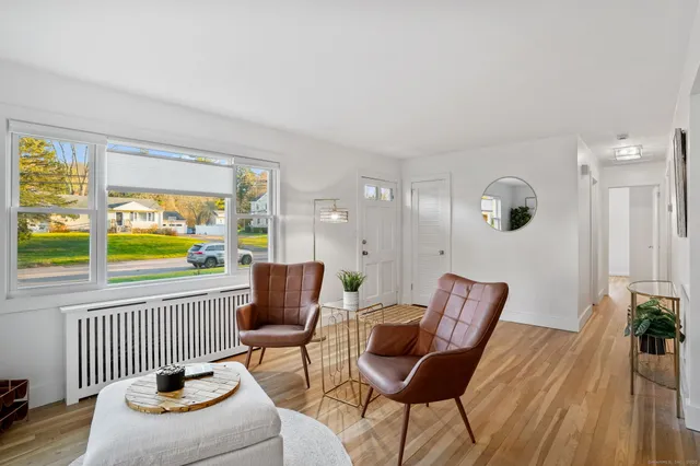 a living room with furniture and a floor to ceiling window