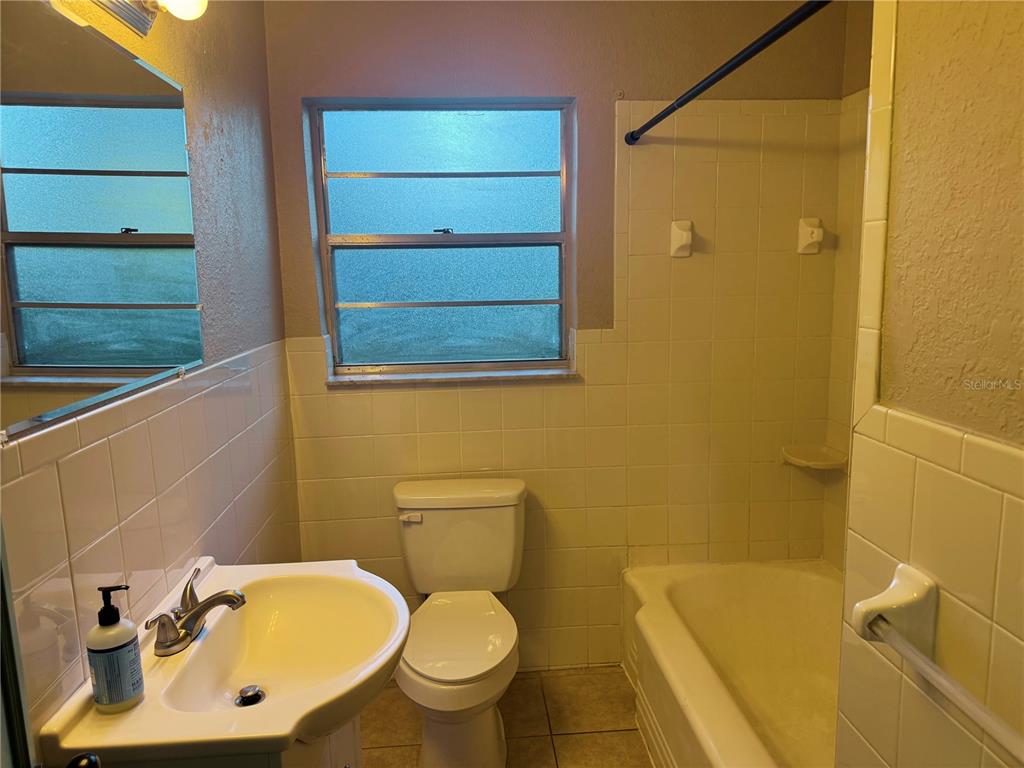 1030 East Walnut Street Lakeland, FL 33801 - Photo 9 of 11 a bathroom with a sink toilet and shower