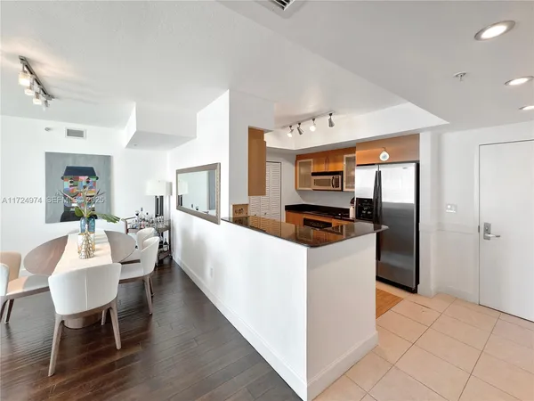 a large white kitchen with a large window