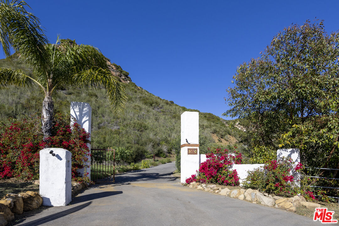 3030 Encinal Canyon Road Malibu, CA 90265 - Photo 3 of 12 a front view of a house with a yard