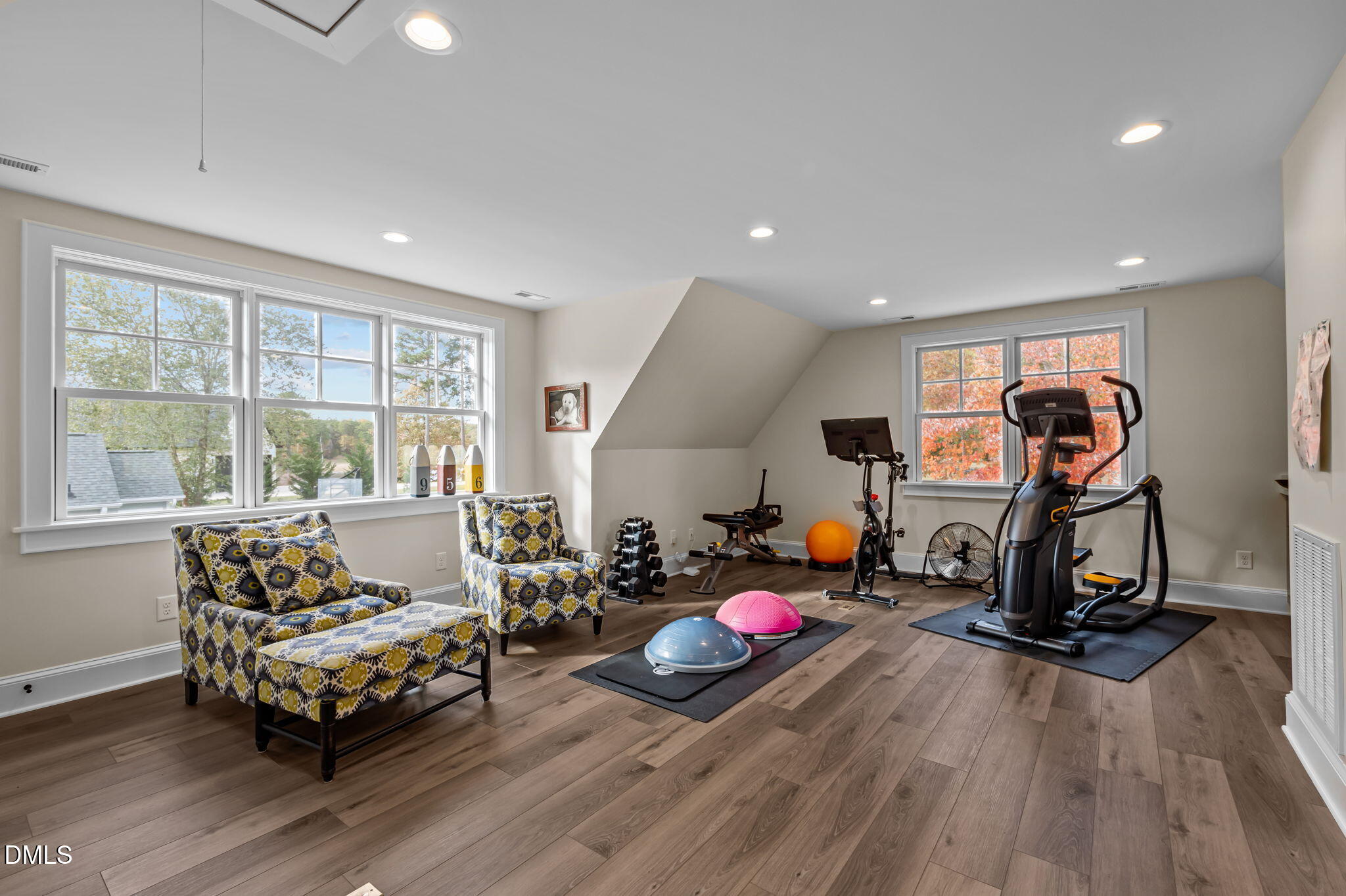515 Oak Pointe Drive Semora, NC 27343 - Photo 35 of 66 a living room with furniture gym equipment and a large window