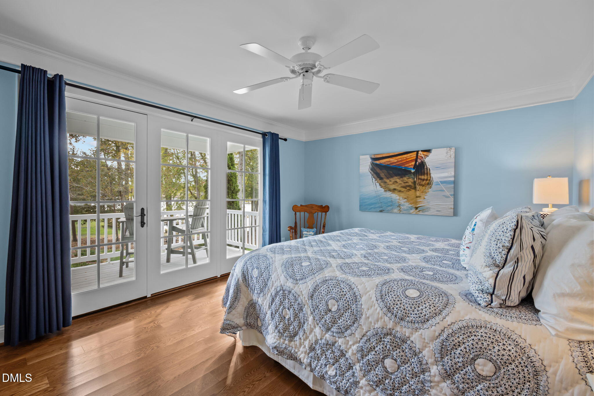 515 Oak Pointe Drive Semora, NC 27343 - Photo 38 of 66 a bedroom with a large bed and a chandelier