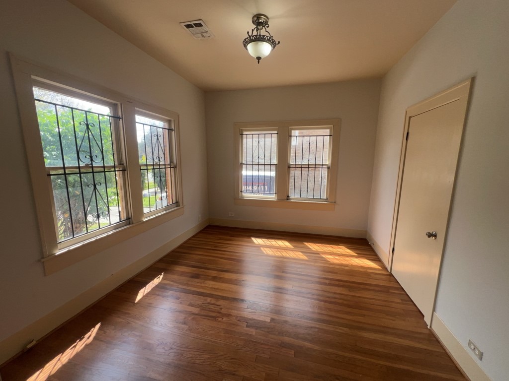 4716 Crawford Street Houston, TX 77004 - Photo 11 of 15 a view of an empty room with wooden floor and a window