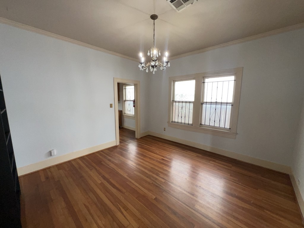 4716 Crawford Street Houston, TX 77004 - Photo 5 of 15 a view of an empty room with wooden floor and a window