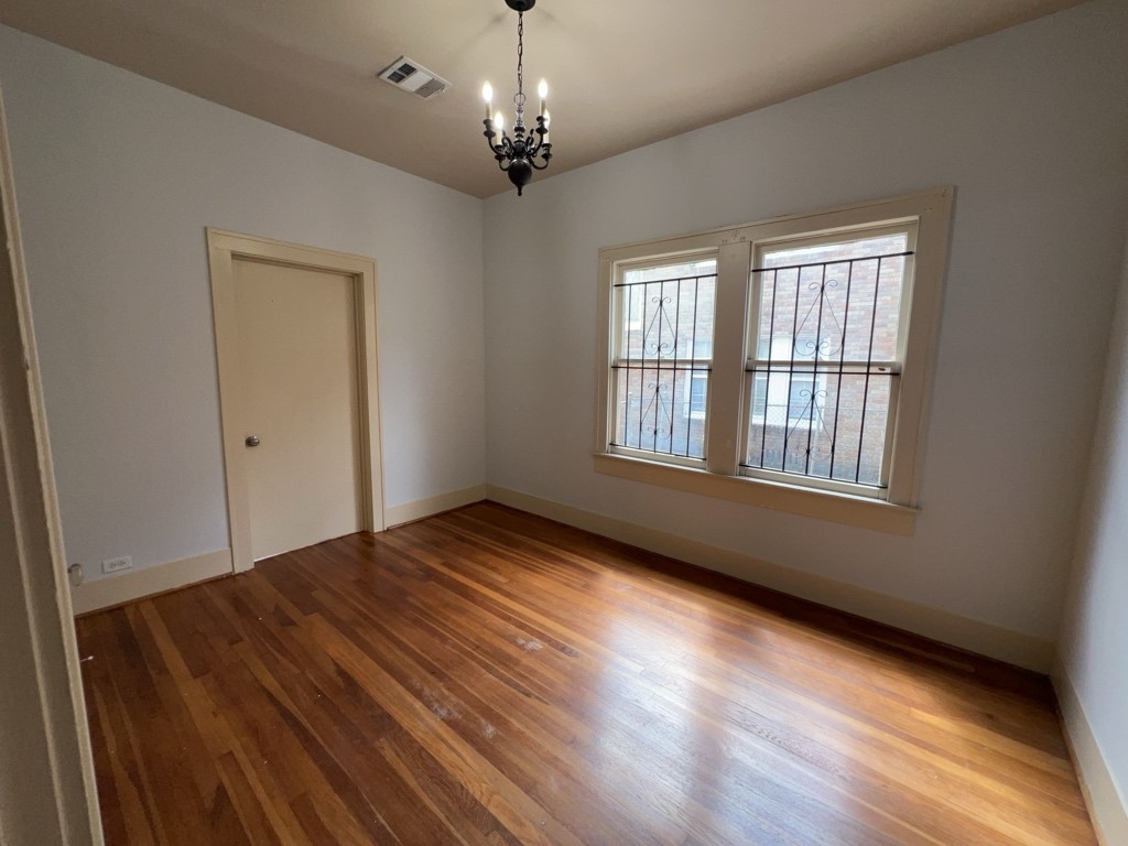 4716 Crawford Street Houston, TX 77004 - Photo 7 of 15 a view of an empty room with wooden floor and a window