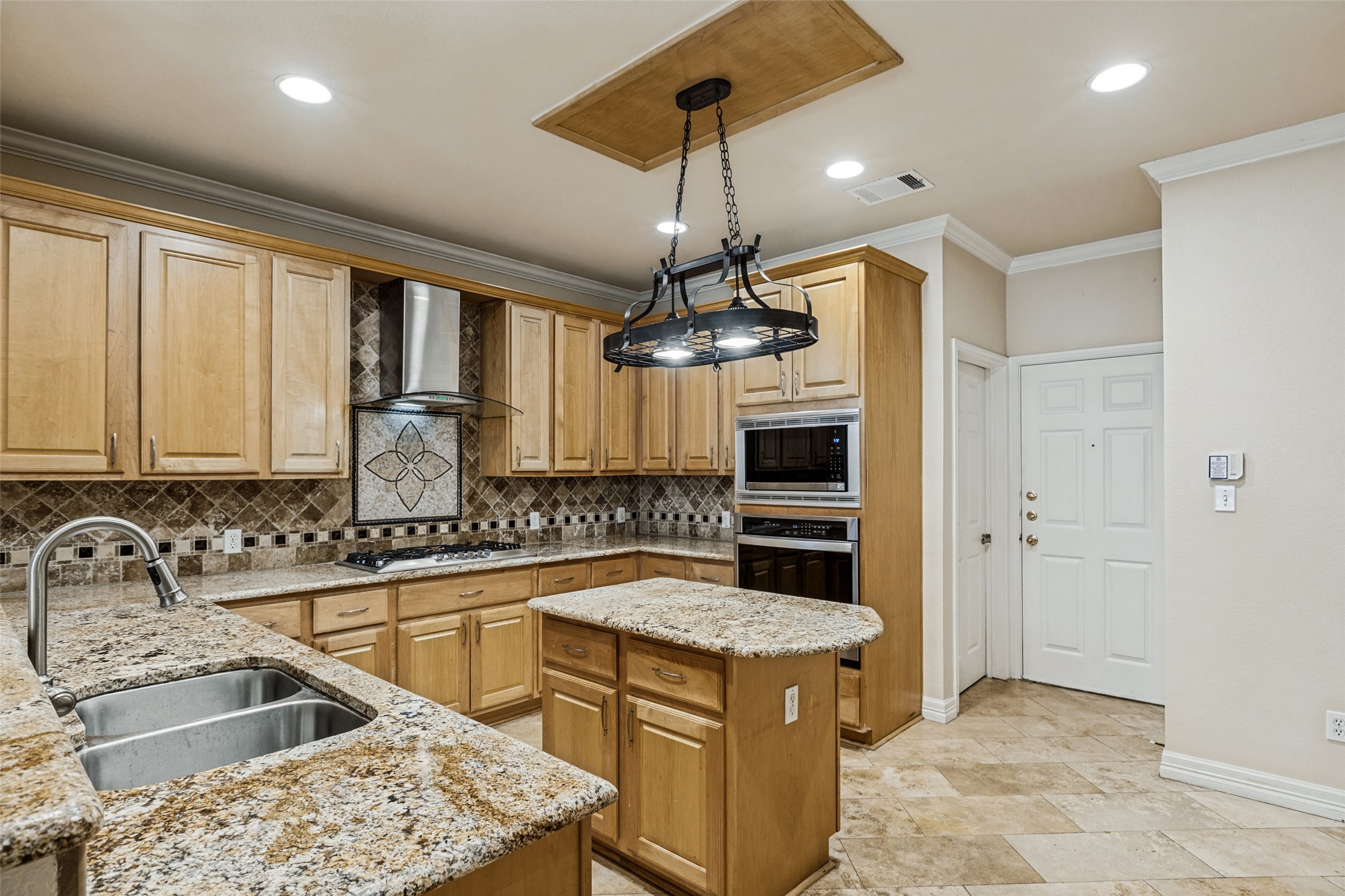 2832 Grimes Ranch Road Austin, TX 78732 - Photo 10 of 23 Gleaming granite countertops pair beautifully with custom wood cabinetry and tiled floors.
