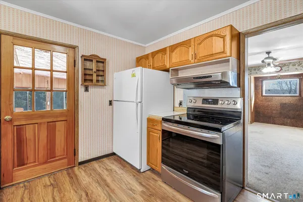 a kitchen with a stove and a refrigerator