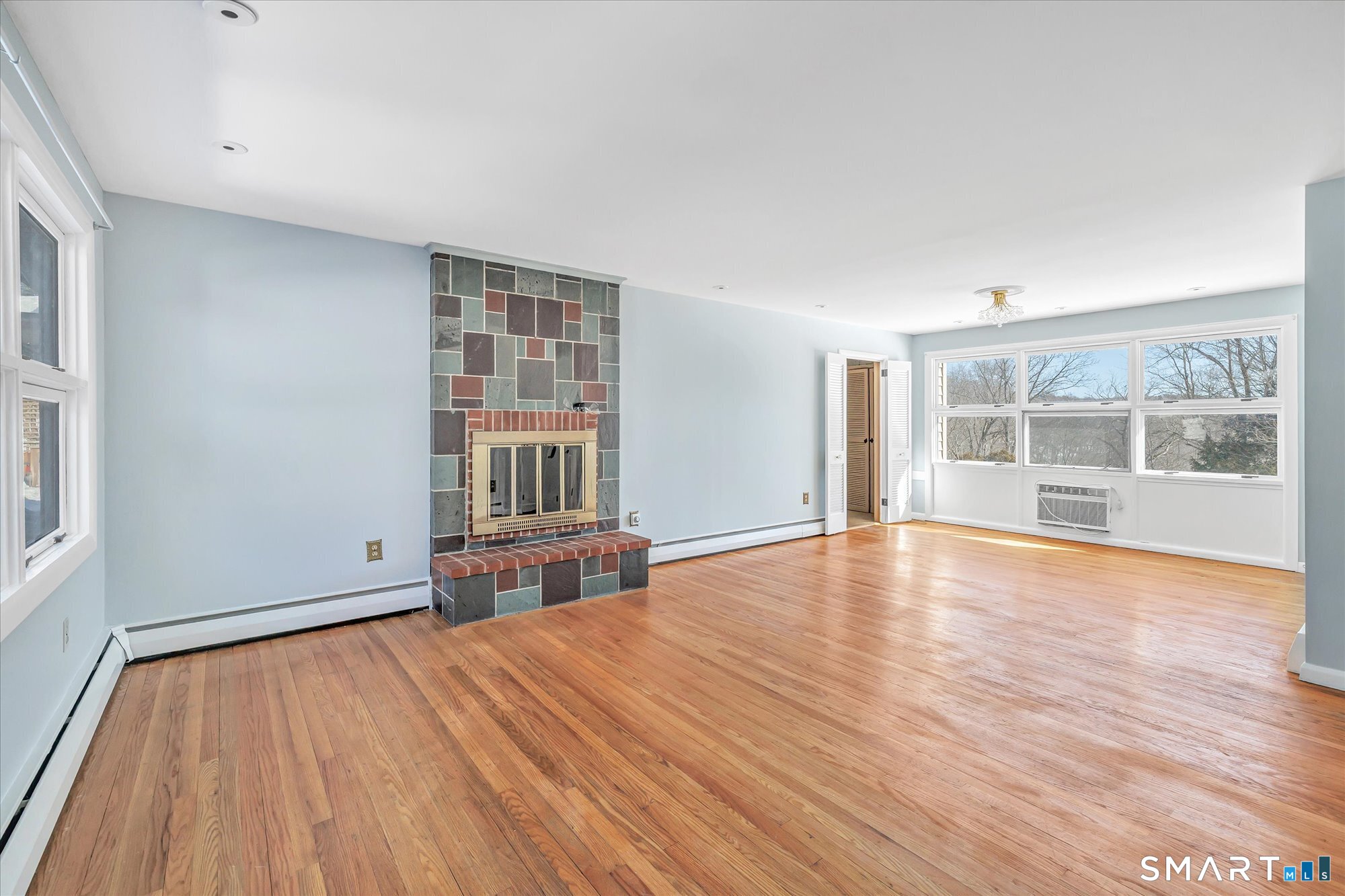 61 Soundview Avenue Shelton, CT 06484 - Photo 3 of 33 a view of empty room with wooden floor and fan