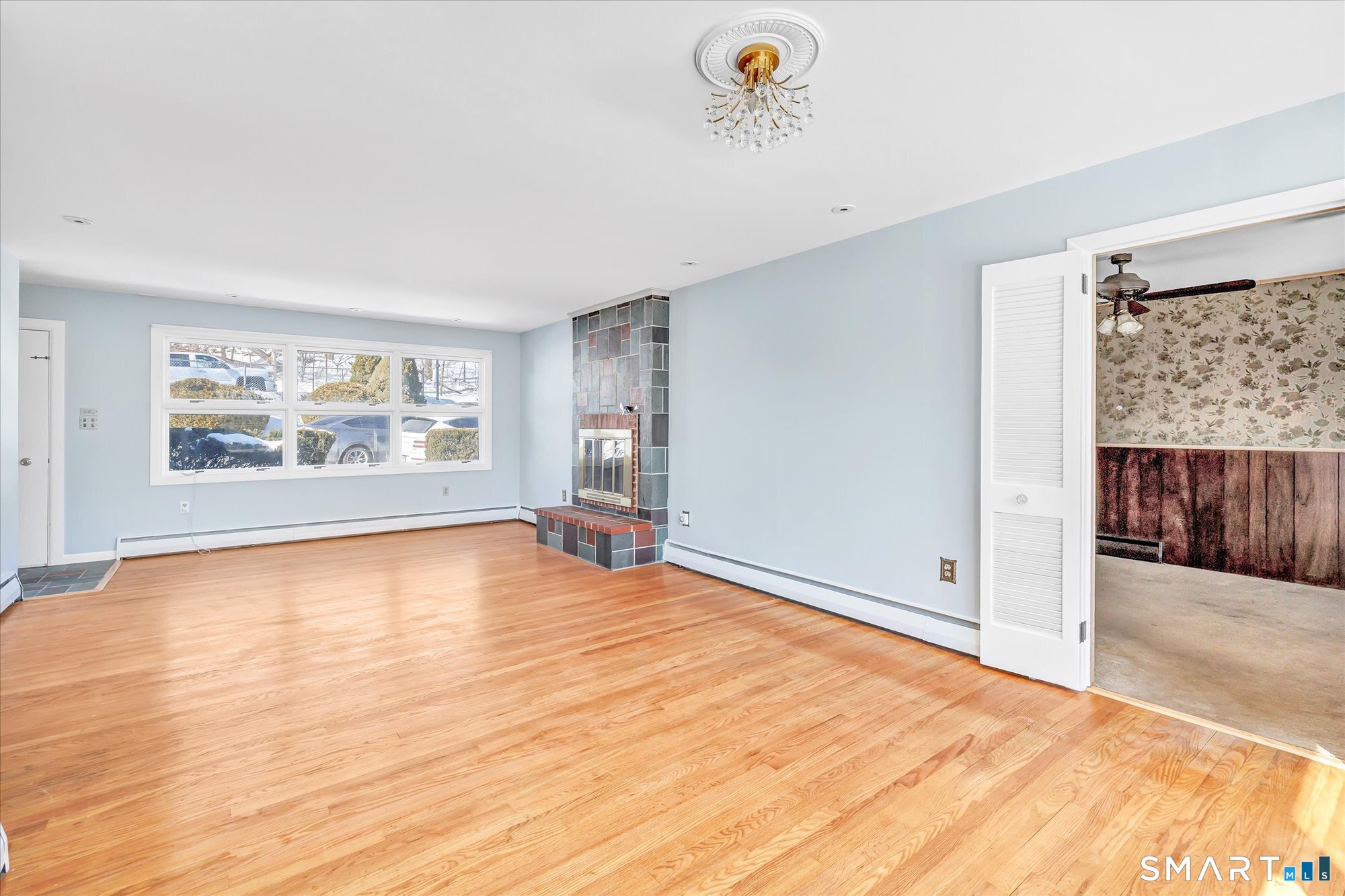 61 Soundview Avenue Shelton, CT 06484 - Photo 6 of 33 a view of an empty room with a window and wooden floor
